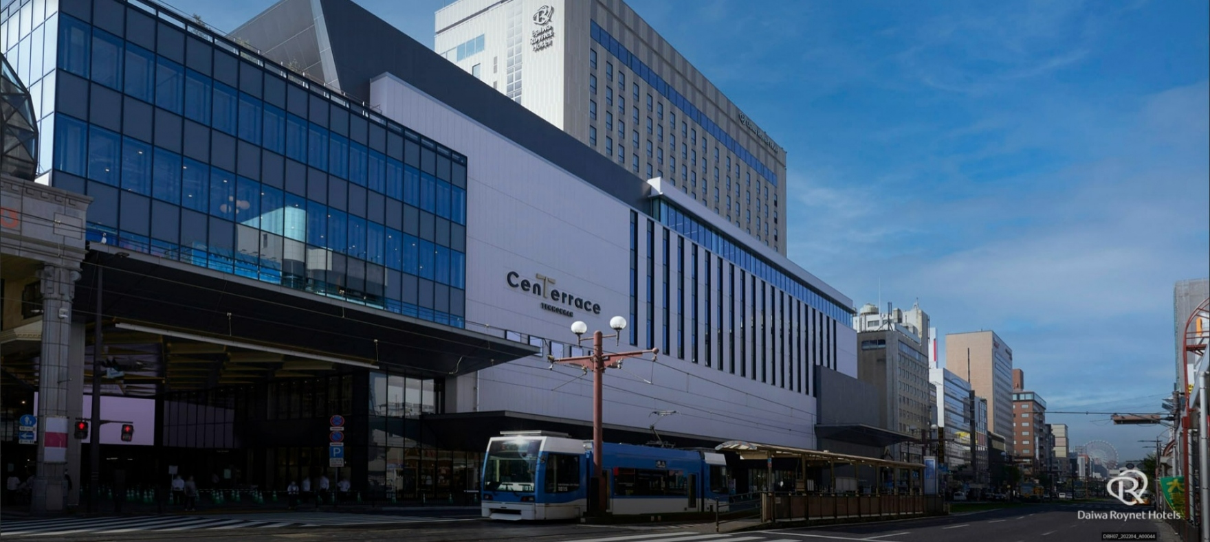 ダイワロイネットホテル鹿児島天文館 PREMIER — 鹿児島市千日町 · 複合施設センテラス天文館の外観と、電停前を走る鹿児島市電