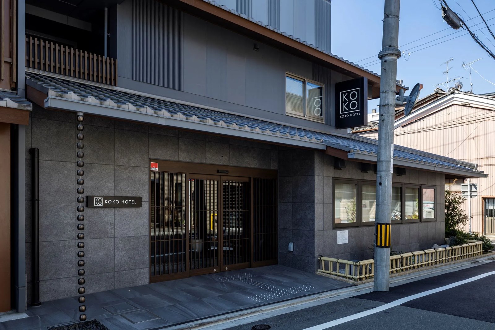 KOKO HOTEL 京都三条 — 京都市左京区・三条京阪 · 瓦屋根の庇と格子戸を備えたホテルの外観と正面入口